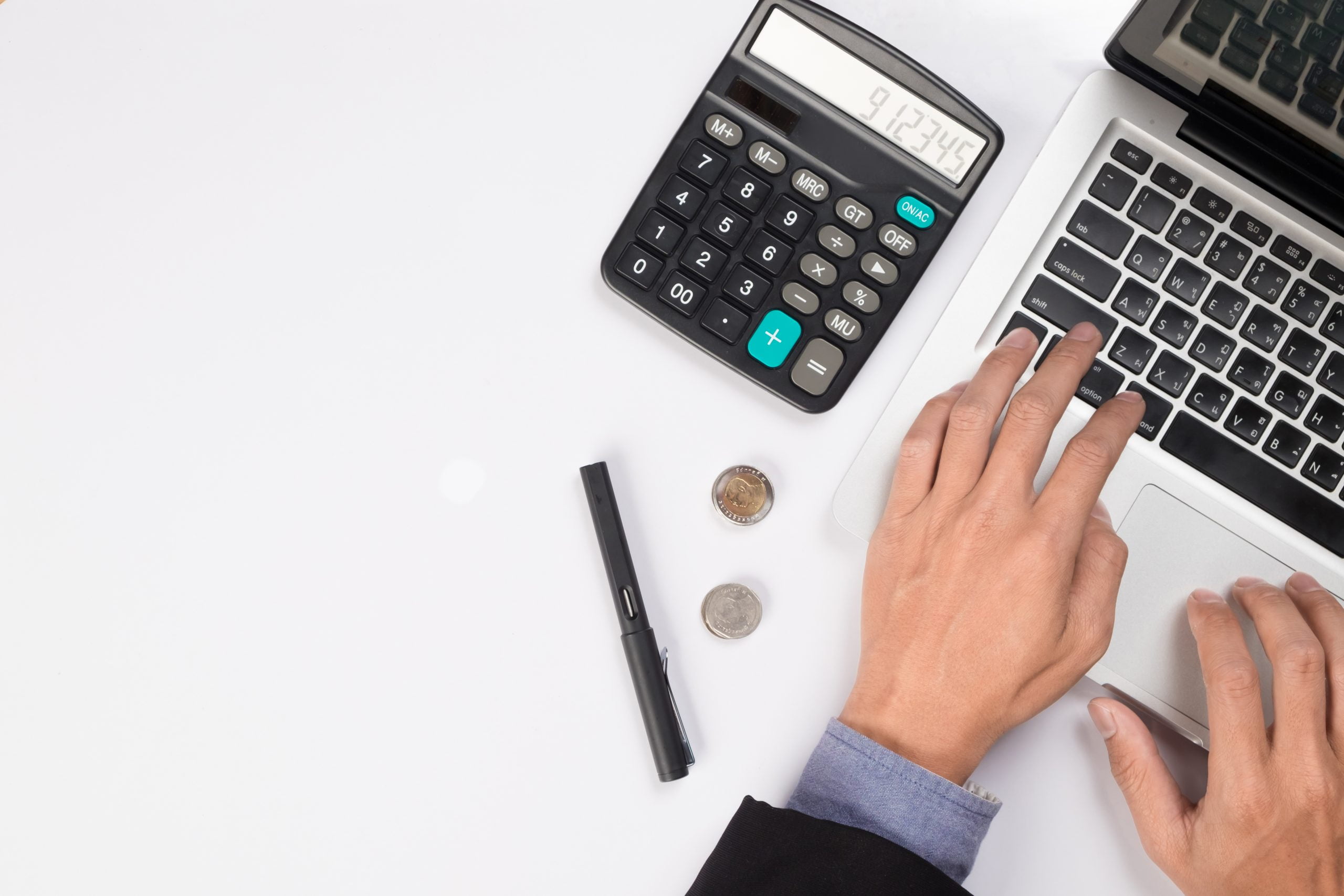 Thoughtful businessman sitting with open laptop computer looking Get Business Accounting in order through Software Consolidation